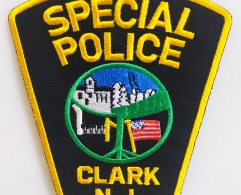 a custom shape embroidery patch for a cop of new jersey clark rank police officer heading as SPECIAL POLICE in yellow thread satin embroidery and edge, a round part in centre show American flag and department symbol