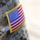 American flag embroidered patch shows on shoulder of soldier uniform